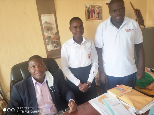Mariam with her Head Teacher and Asante Africa Staff
